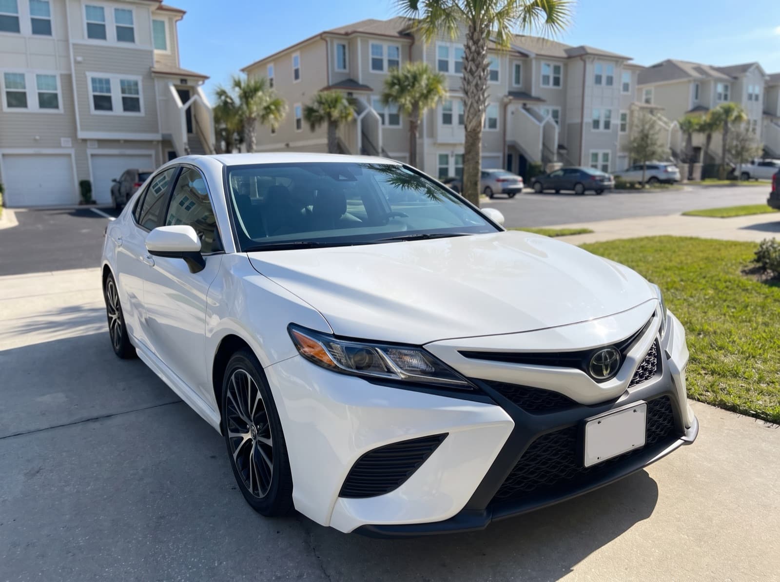 A white sedan in a driveway in St. Augustine Beach, FL, after a Bang AutoGlass mobile glass job